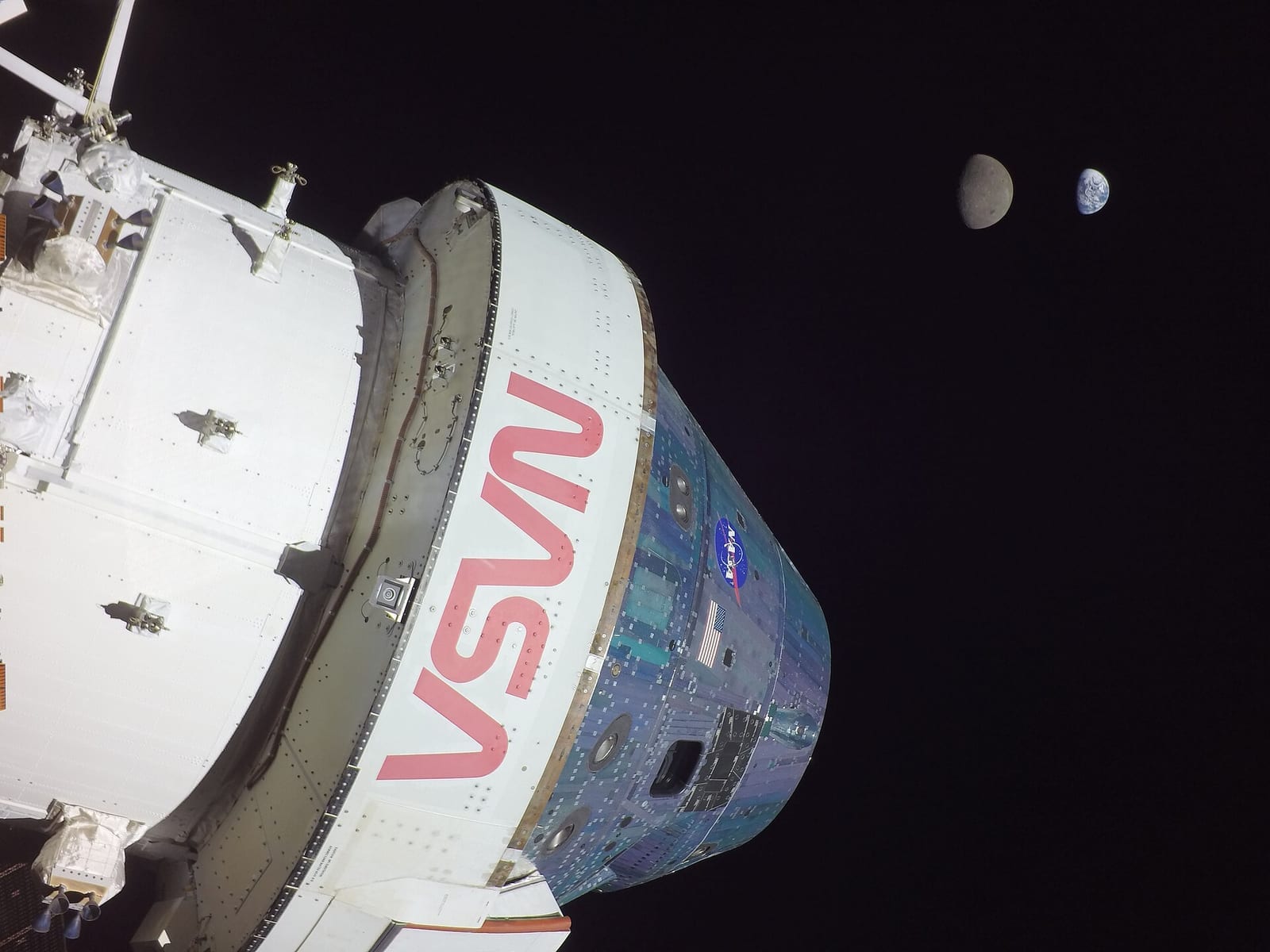 The Orion spacecraft photographed near the Moon during the Artemis I mission with Earth in the distance