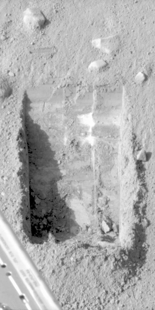 Side-by-side images of the Dodo-Goldilocks trench dug by Phoenix, showing bright chunks of water ice subliming away over four Martian days