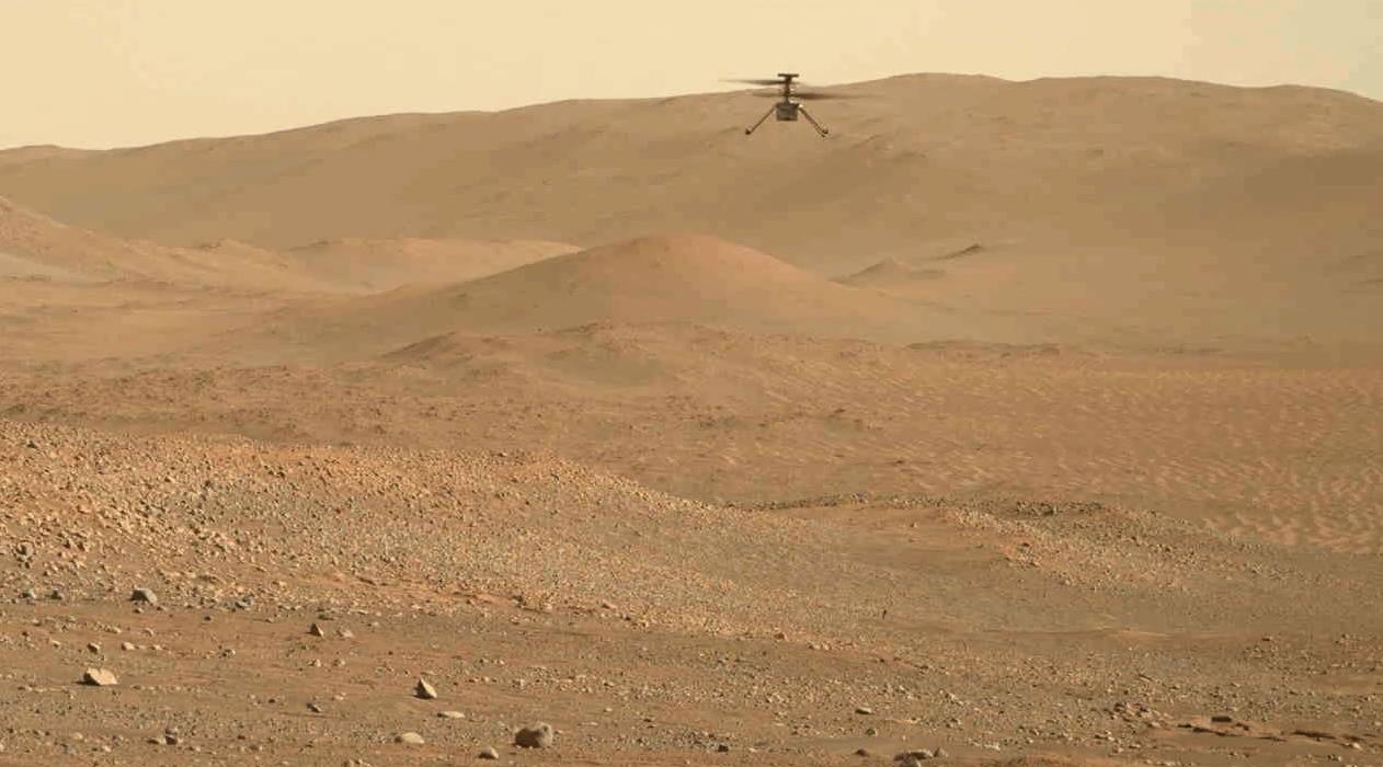 NASA’s Ingenuity helicopter hovering above the Martian surface, seen from the Perseverance rover
